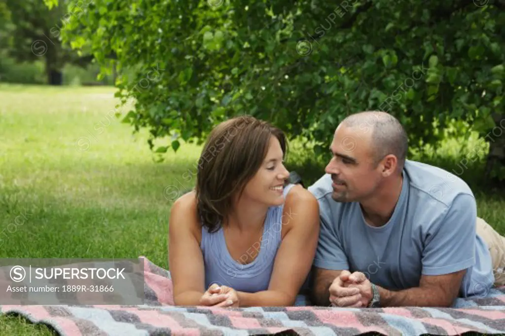 Couple laying together on a blanket