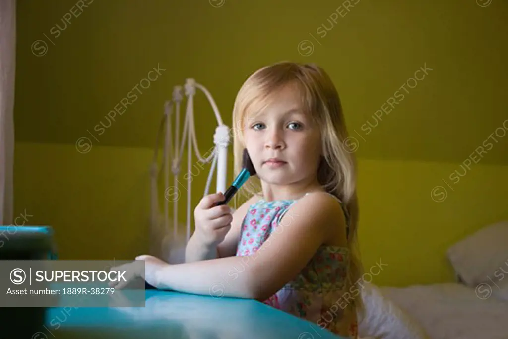 Girl playing with make up brush