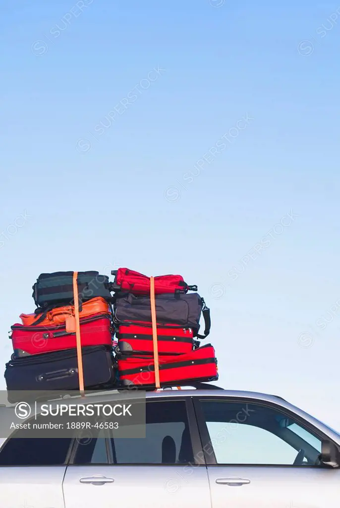 Luggage piled high on a car roof