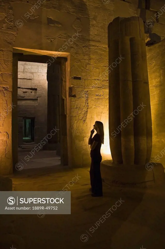 Woman tourist in Luxor Temple at night, Egypt