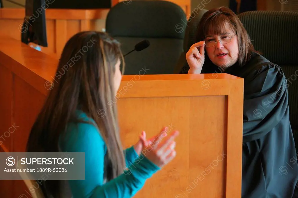 a teenage girl talking to a judge
