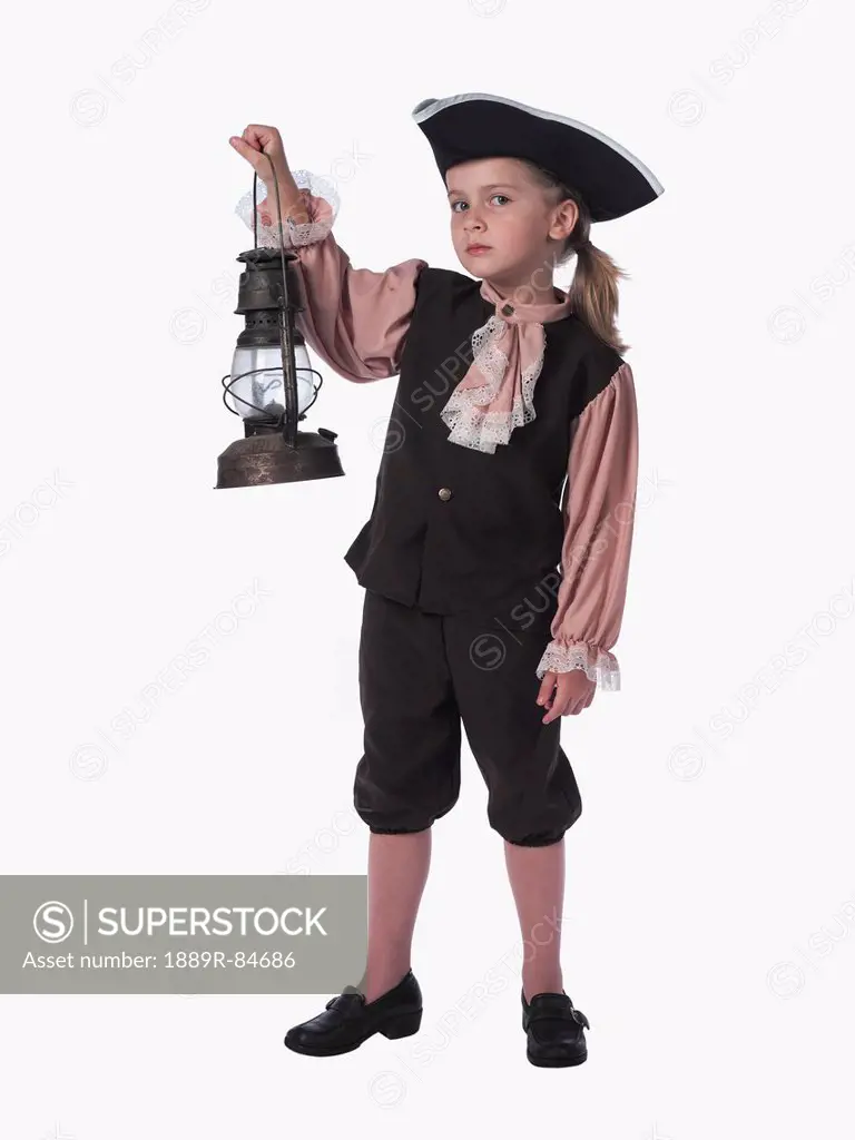 Child in a pirate costume holding a lantern