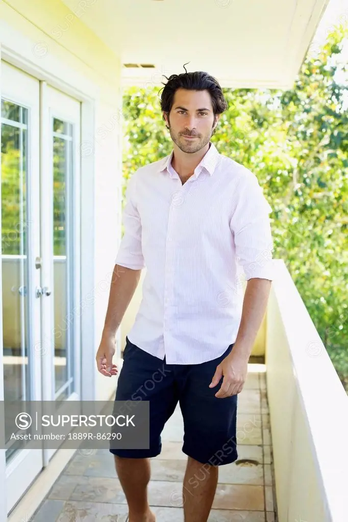 Portrait Of A Man Standing On A Covered Balcony;Wailua Kauai Hawaii United States Of America