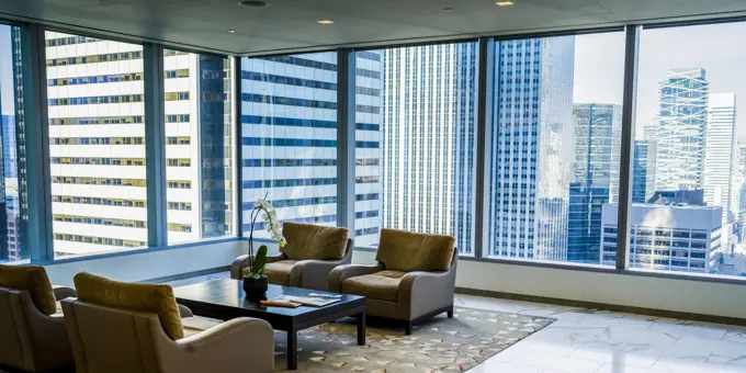 Living Room In A Condominium With Glass Walls And A View Of The Skyscrapers Surrounding It; Toronto, Ontario, Canada