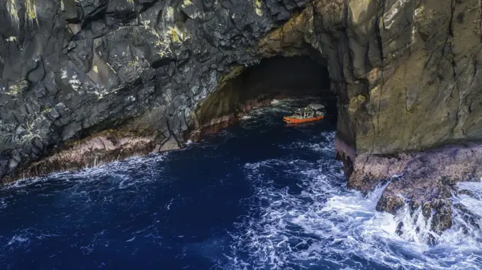 An aerial view of a vessel beside Mokumanu Island, outside of Kaneohe Bay off the North shore of Oahu; Oahu, Hawaii, United States of America