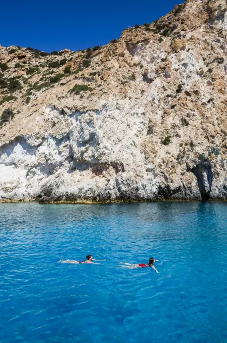 Tourists swimming, Galazia Nera Bay; Polyaigos Island, Cyclades, Greece