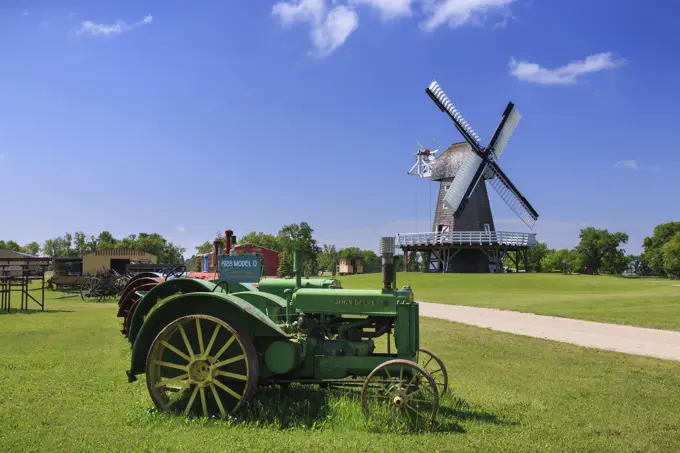Tractors And Windmill In Mennonite Heritage Village; Steinbach, Manitoba, Canada