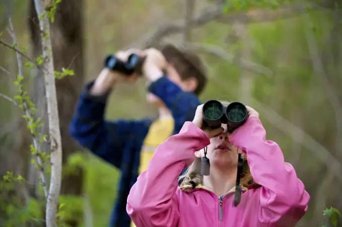 Siblings birdwatching with binoculars; Peru, Nebraska, United States of America