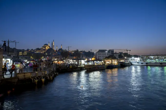 View of boats near Eminonu Square at night in Fatih, Istanbul; Istanbul, Turkey