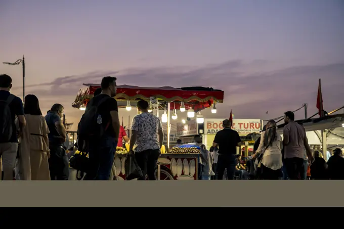 Street vendor in Eminonu Square at night in Fatih, Istanbul; Istanbul, Turkey