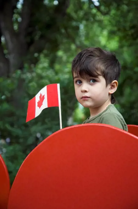 Boy holding a Canadian flag