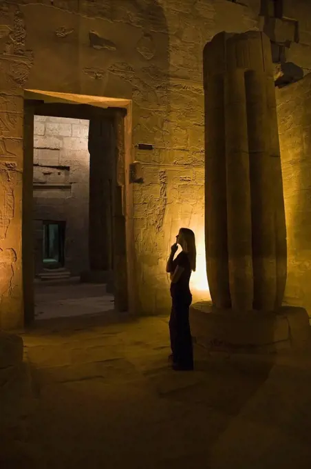 Woman tourist in Luxor Temple at night, Egypt