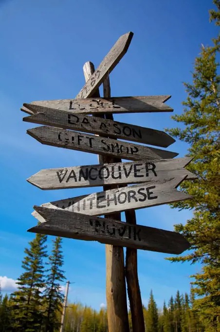 Rustic canadian wooden destination sign post, stewart crossing, yukon, canada