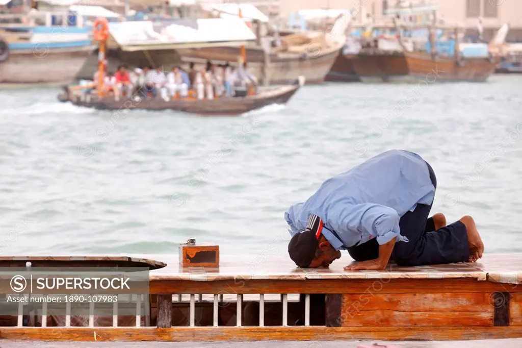 Praying muslim in Dubai harbour, Dubai, United Arab Emirates, Middle East