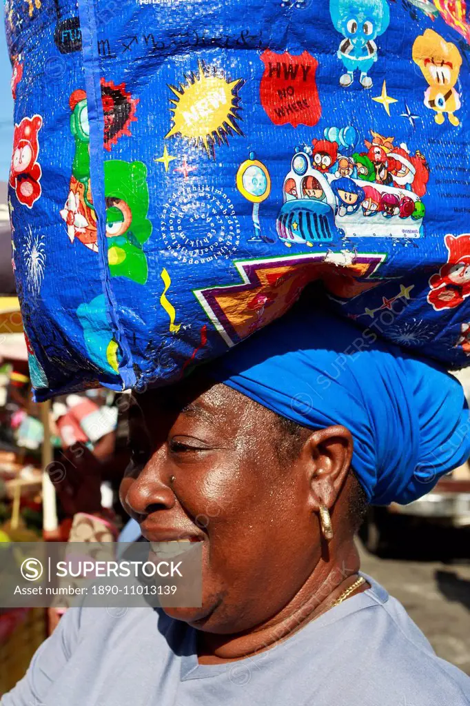 Lady with shopping bag on head, market, Roseau, Dominica, West Indies, Caribbean, Central America