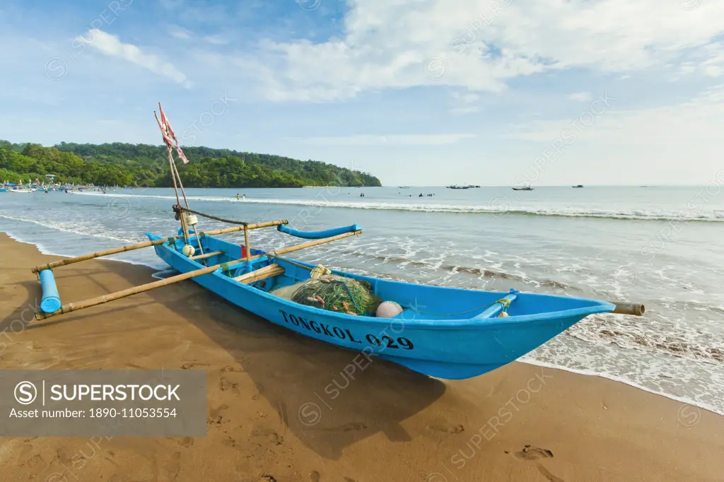 Outrigger fishing boat on west beach of the isthmus at this major beach resort on the south coast, Pangandaran, Java, Indonesia, Southeast Asia, Asia