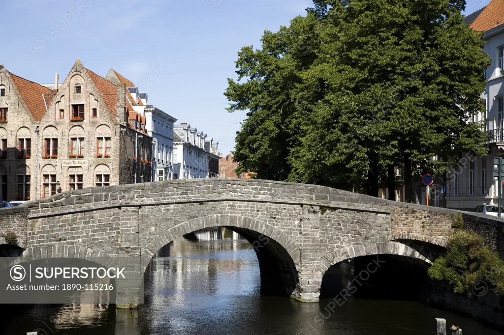 Stone bridge over canal with medieval buildings in background, Bruges, Belgium, Europe