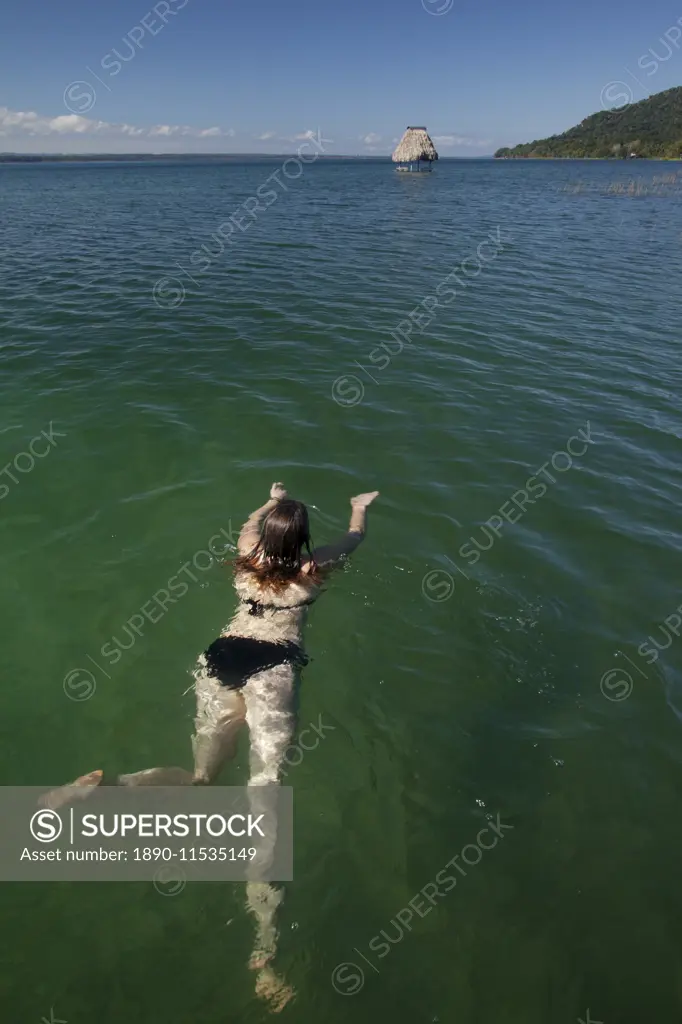 Woman swimming in Lago Peten Itza, Guatemala, Central America