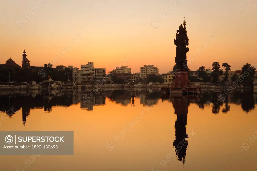 Statue of Shiva rising out of a Lake Sur Sagar in the centre of Vadodara, Gujarat, India, Asia