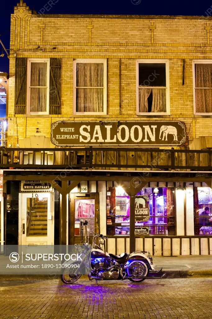 Bike outside a bar in Fort Worth Stockyards at night, Texas, United States of America, North America