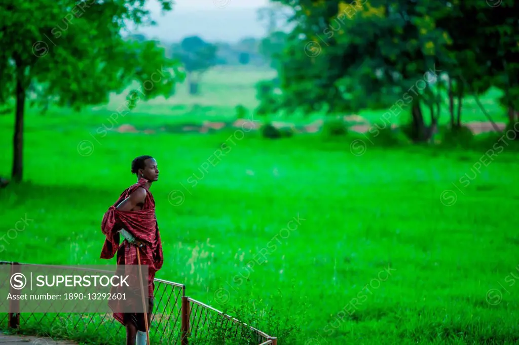 Maasai warrior stands guard, Mizumi Safari Park, Tanzania, East Africa, Africa