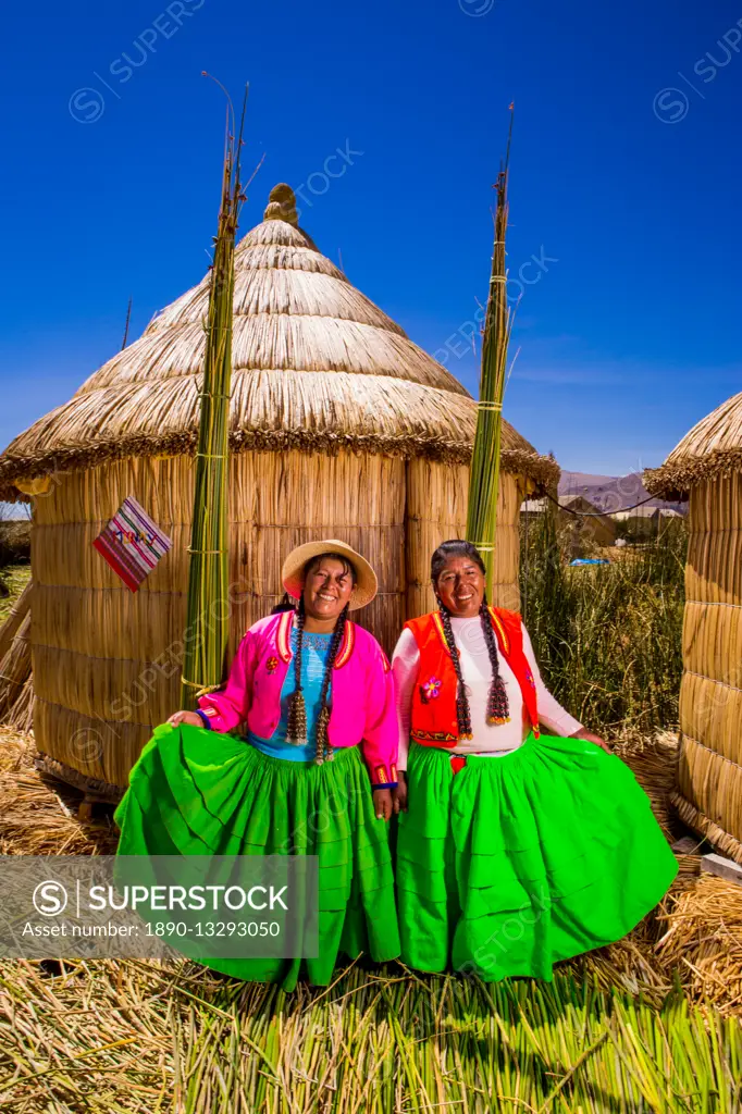 Two Quechua Indian women on Floating Grass islands of Uros, Lake Titicaca, Peru, South America