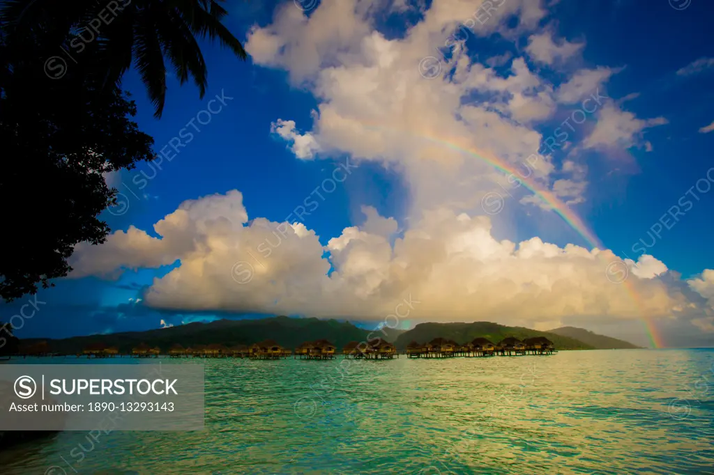 Rainbow arcing over the overwater bungalows, Le Taha'a Resort, Tahiti, French Polynesia, South Pacific, Pacific