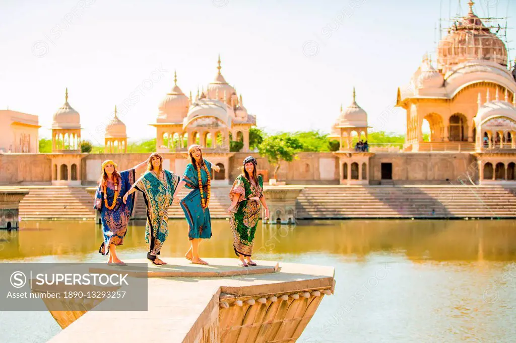 Female tourists stand in front of Temple during Holi Festival, Vrindavan, Uttar Pradesh, India, Asia