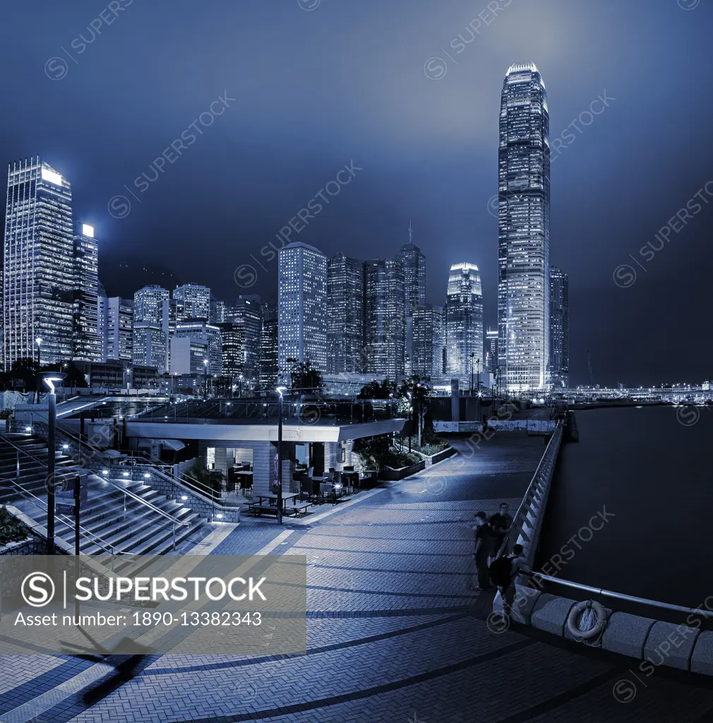 Central and Western district promenade leads through to skyscrapers on Hong Kong island above Victoria Harbour at night, Hong Kong, China, Asia