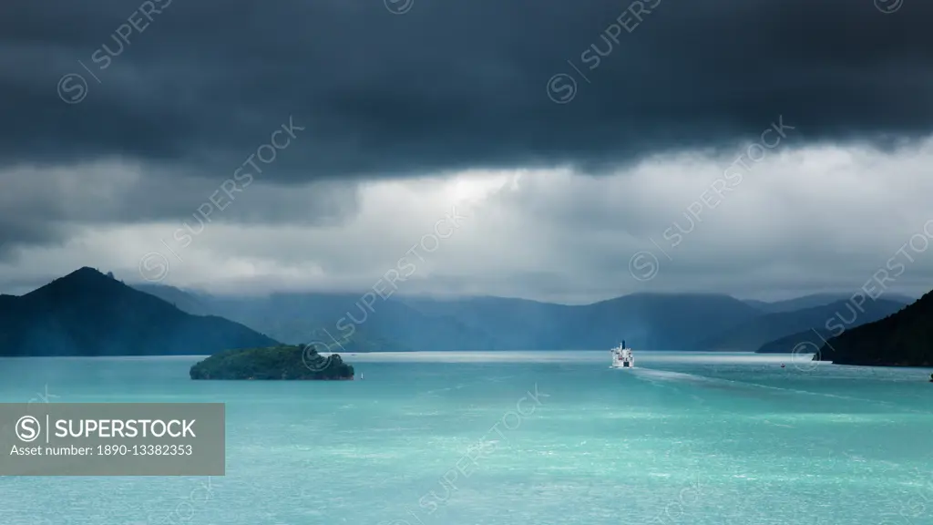 The narrow passageway of Queen Charlotte Sound with a ferry boat navigating its way through to the Cook Straits, Marlborough, South Island, New Zealan...