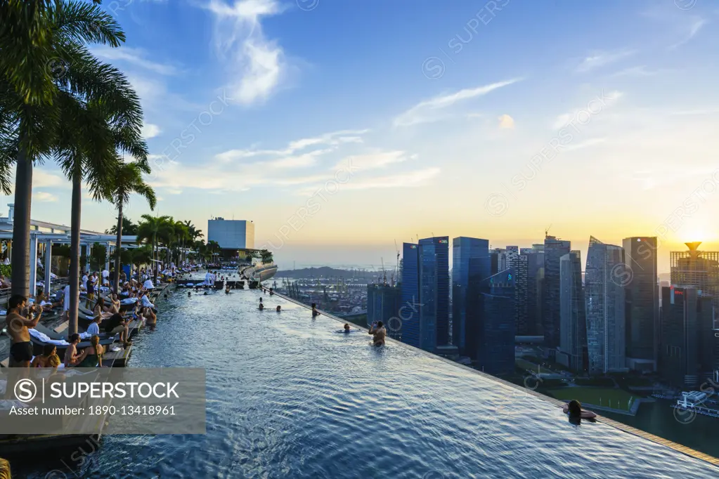 Infinity pool on the roof of the Marina Bay Sands Hotel with spectacular views over the Singapore skyline at sunset, Singapore, Southeast Asia, Asia