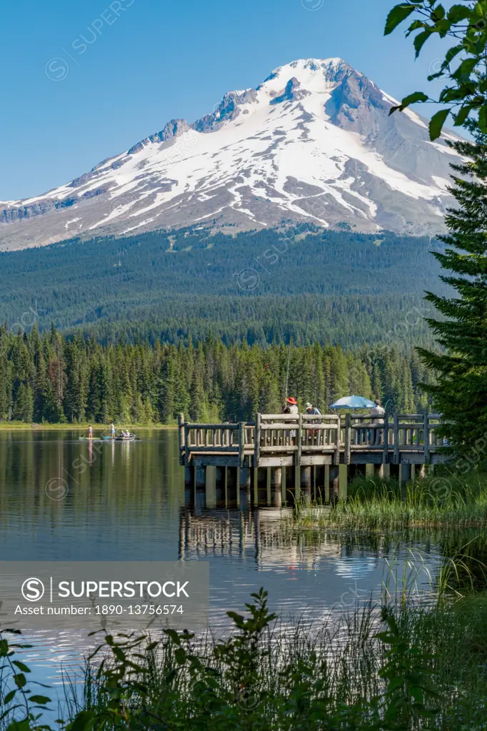 Fishing on Trillium Lake with Mount Hood, part of the Cascade Range, reflected in the still waters, Oregon, United States of America, North America