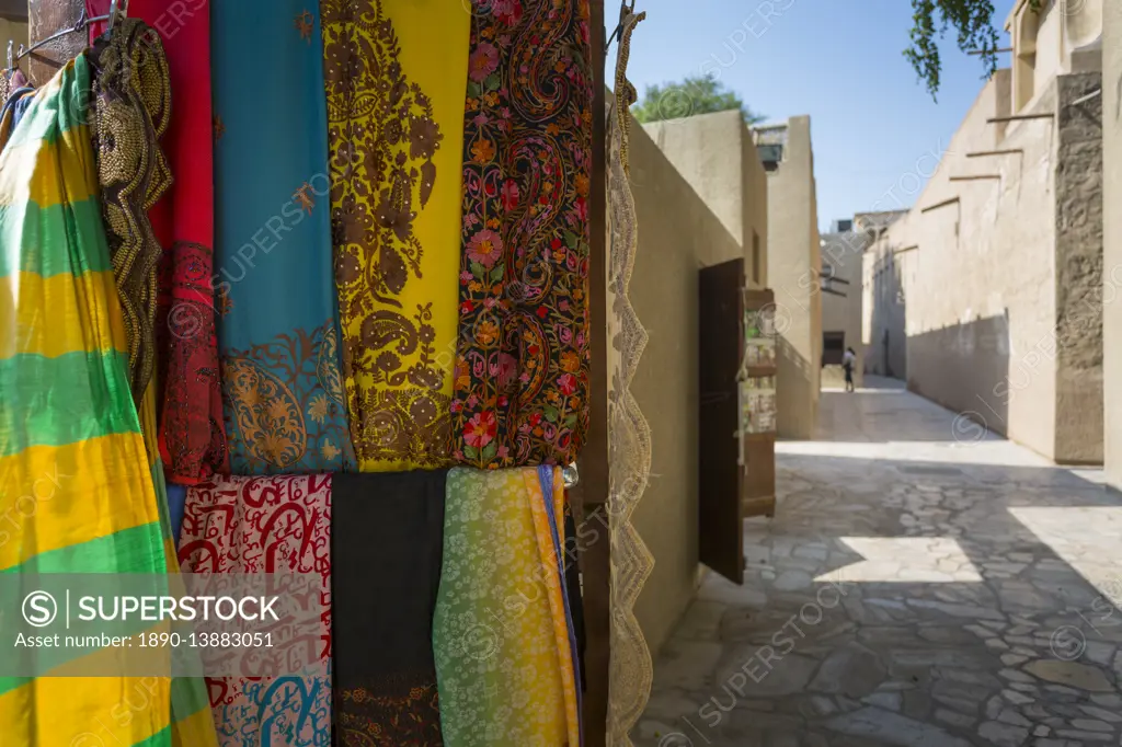 Narrow street and fabric shop in Al Fahidi Historical Centre, Bur Dubai, Dubai, United Arab Emirates, Middle East