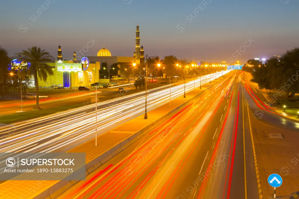 Sultan Qaboos Grand Mosque and traffic on Sultan Qaboos Street at sunset, Muscat, Oman, Middle East