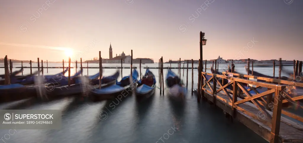 View towards San Giorgio Maggiore at dawn from Riva Degli Schiavoni, with gondolas in foreground, Venice, UNESCO World Heritage Site, Veneto, Italy, E...