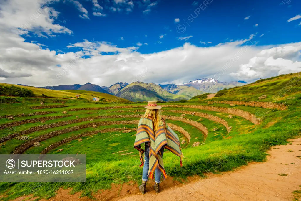 Woman looking out at Inca ruins, Moray, Peru, South America