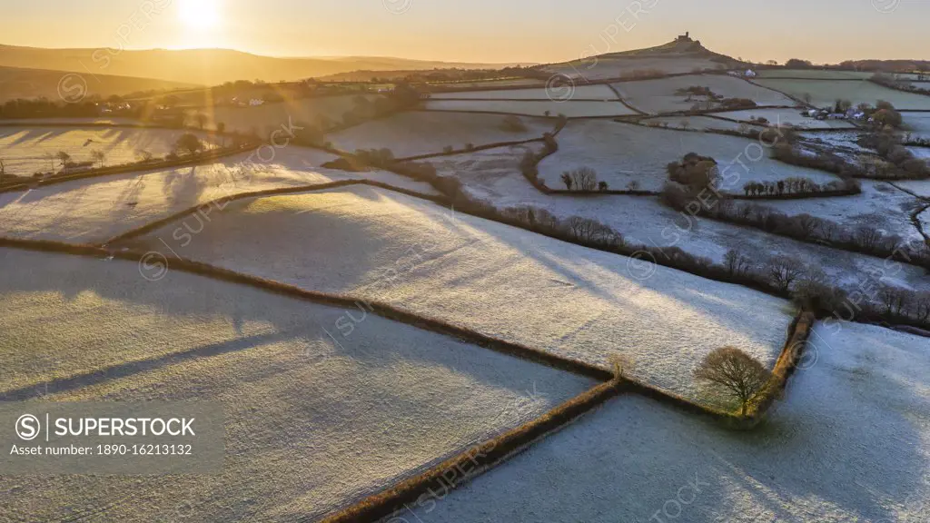 View by drone of frosty winter sunrise over Dartmoor countryside near Brentor, Devon, England, United Kingdom, Europe