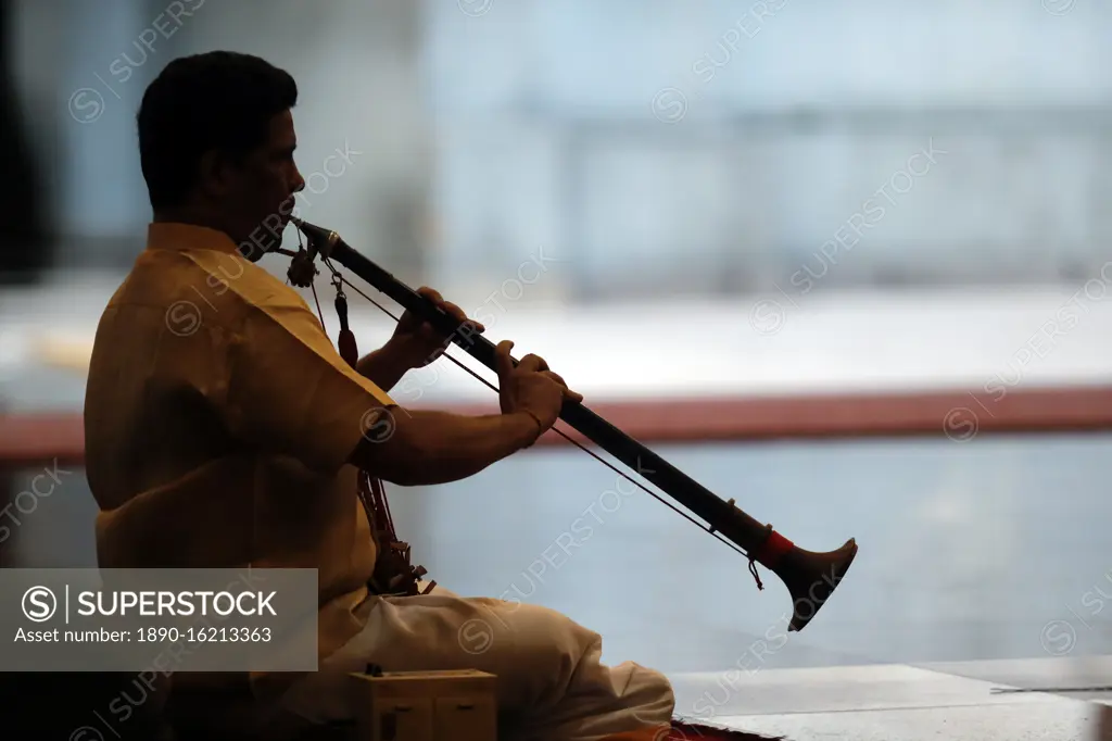 Musician playing a Nadaswaram, a tradional Indian wind instrument, Sri Mahamariamman Hindu Temple, Kuala Lumpur. Malaysia, Southeast Asia, Asia