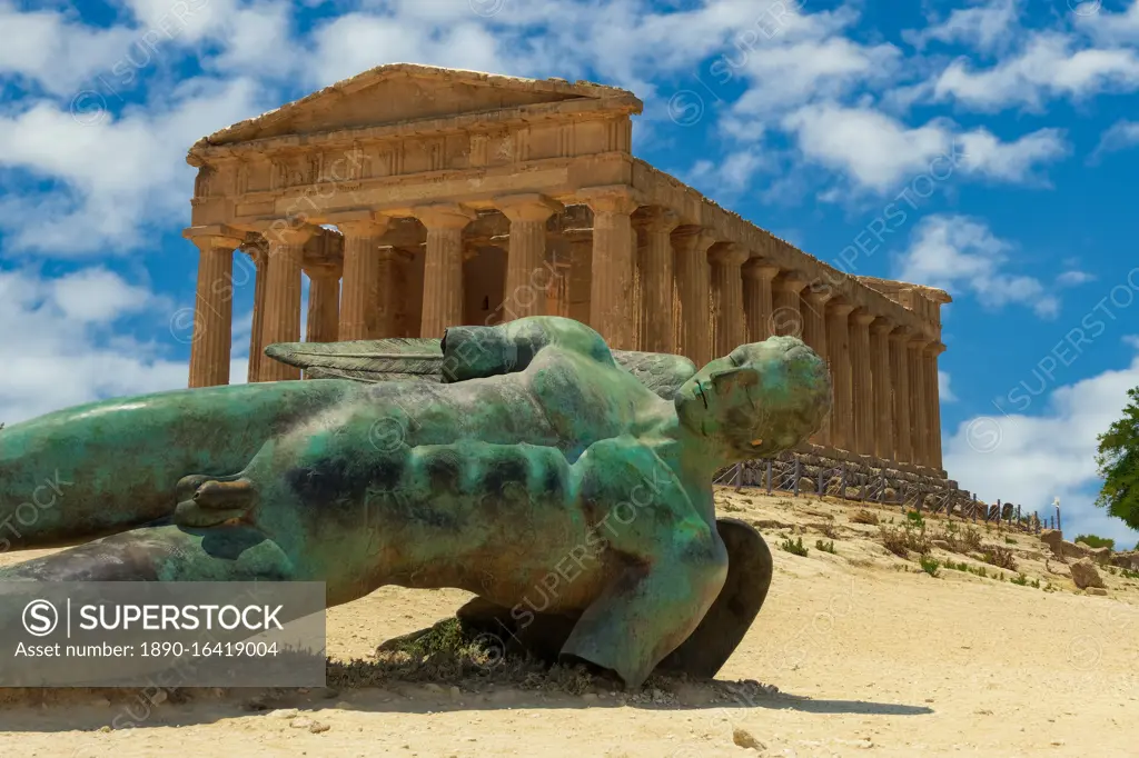 Temple of Concordia with statue, ancient Greek Doric temple with Fallen Icarus bronze statue in Valley of the Temples, Agrigento, UNESCO World Heritage Site, Sicily, Italy, Europe