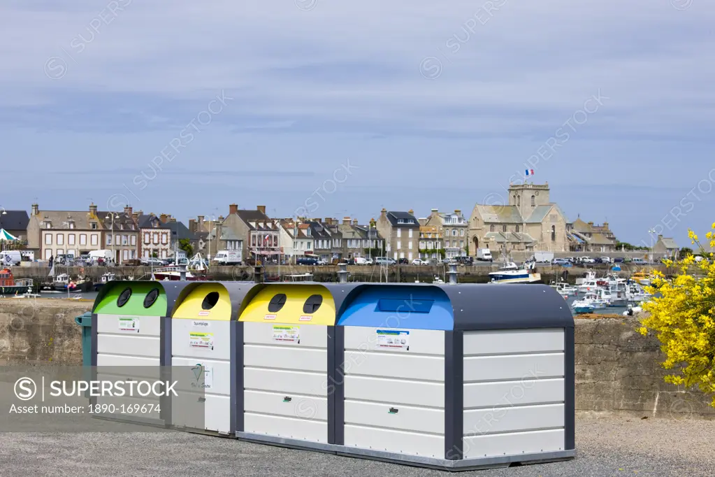 Large plastic recycling bins, dechetterie, for plastic, paper, glass spoil the view in Barfleur in Normandy, France