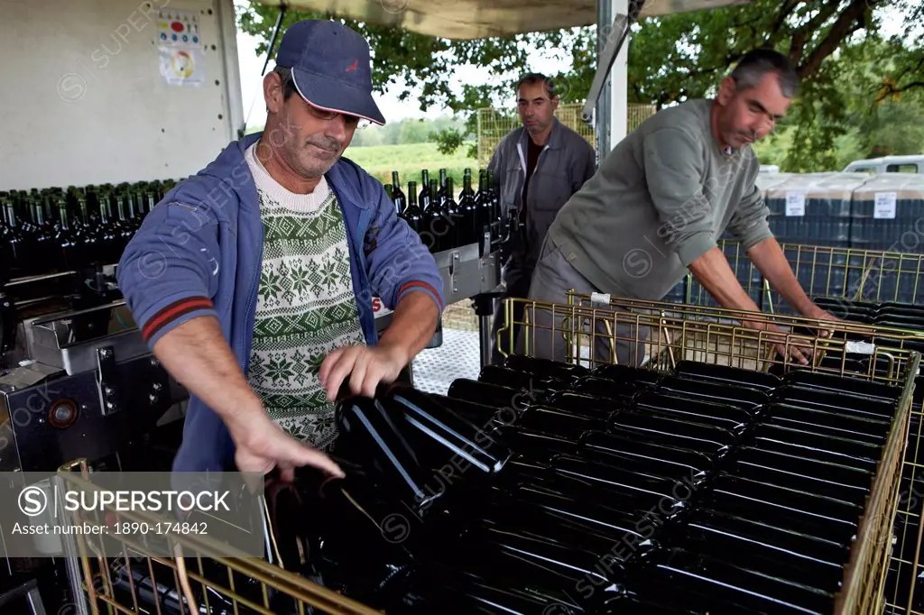 Wine bottling truck with mobile bottling line at Chateau Fontcaille Bellevue vineyard in Bordeaux region of France