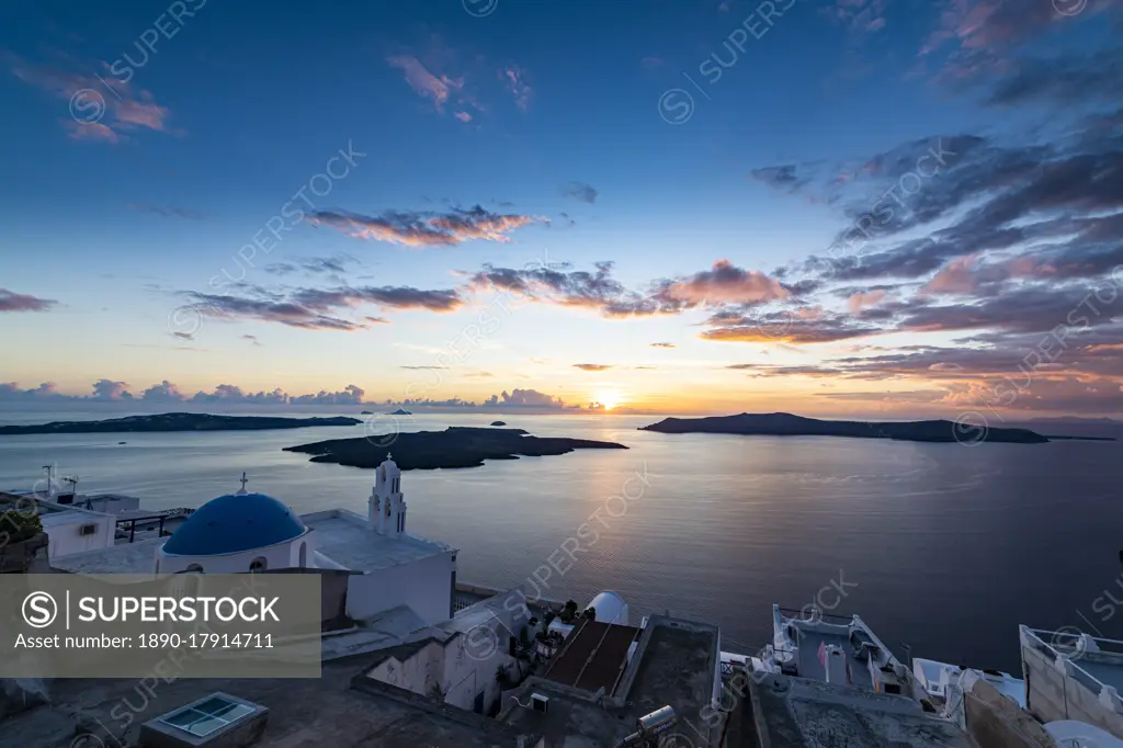 Sunset over the volcanic islands of Santorini and Anastasi Orthodox Church at sunset, Fira, Santorini, Cyclades, Greek Islands, Greece, Europe