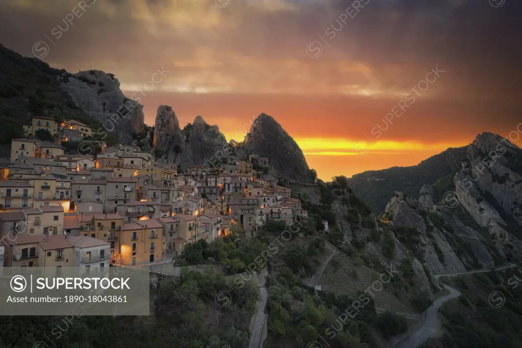 Burning sky at sunrise over the old houses of Castelmezzano and Dolomiti Lucane mountains, Potenza province, Basilicata, Italy, Europe