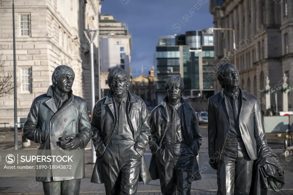 The Beatles statue sculpture at Pier Head on Liverpool WateRoyaltyFreeront, Liverpool, Merseyside, England, United Kingdom, Europe