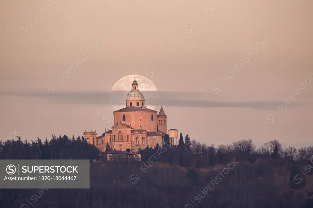 Full moon and a small cloud behind San Luca church (Madonna di San Luca). Bologna, Italy, Europe