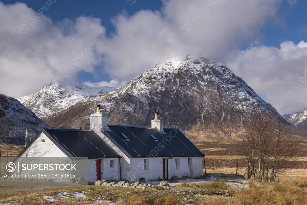 Black Rock Cottage bothy on Rannoch Moor with a snow dusted Buachaille Etive Mor looming behind in winter, Highlands, Scotland, United Kingdom, Europe