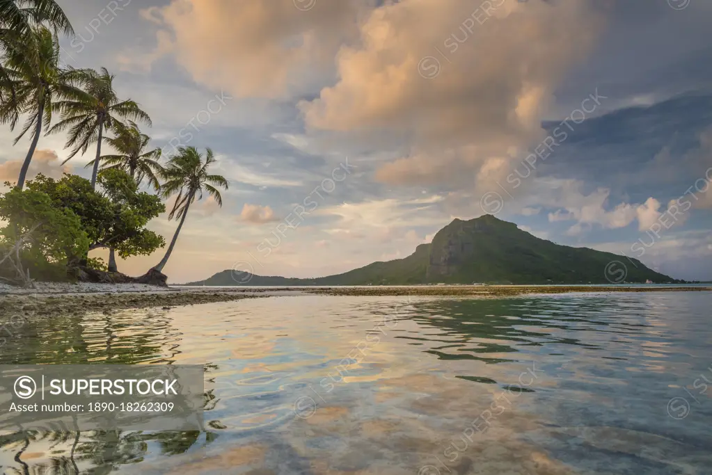 A calm evening in the lagoon of Bora Bora as a cloud forms on top of the mountain, Bora Bora, Tahiti, Society Islands, French Polynesia, Pacific