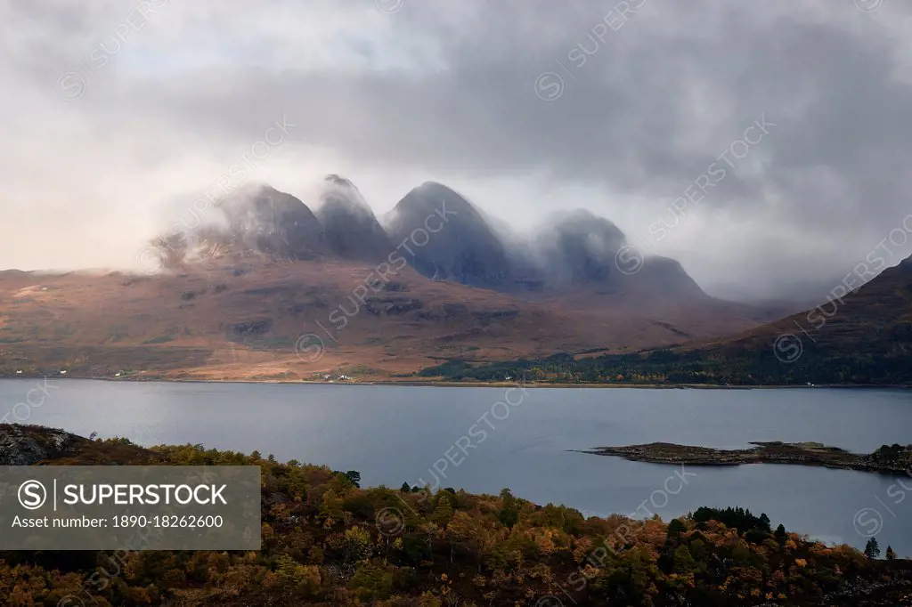 Mountains in the mist facing a lake in the Scottish Highlands, Scotland, United Kingdom, Europe