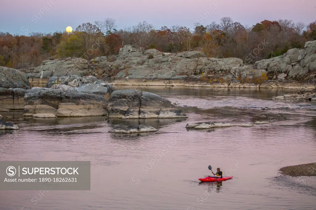 A kid paddles his kayak on the Potomac River at Cabin John, to watch the rising super moon of November 2016, Maryland, United States of America, North America