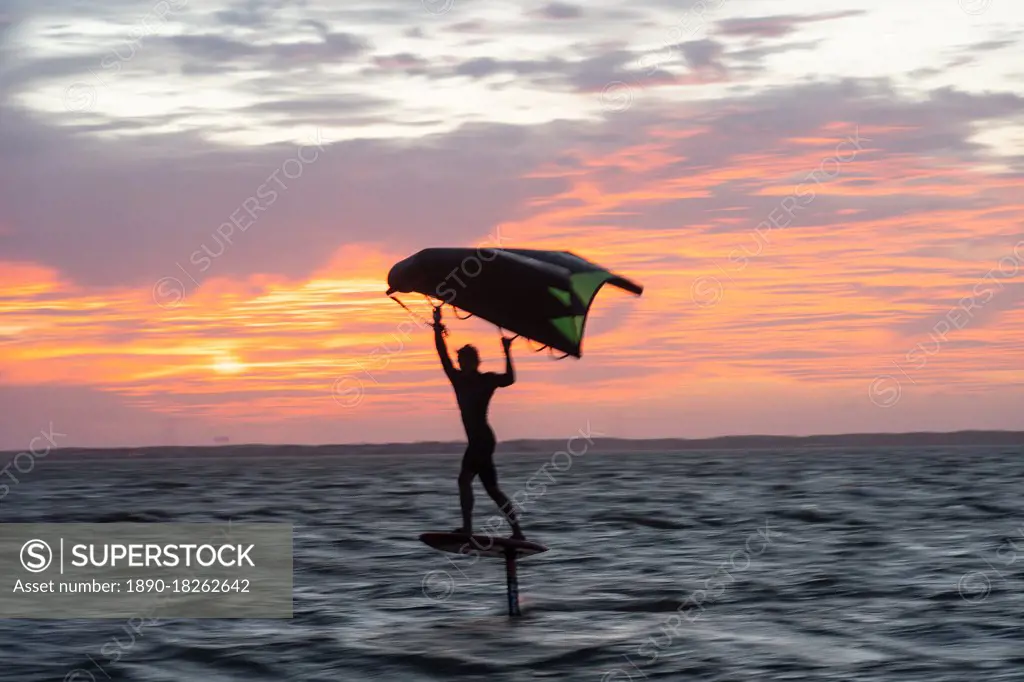 Pro surfer James Jenkins on his wing surfer flies across the Pamlico Sound at Nags Head, North Carolina, United States of America, North America